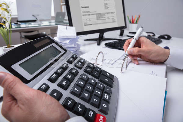 Businessperson's Hand Calculating Bill Stock photo © AndreyPopov