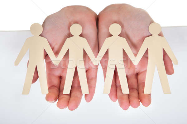 Male Hand Holding Human Figure Cutout Stock photo © AndreyPopov