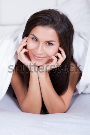 Beautiful woman relaxing in bed Stock photo © AndreyPopov