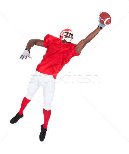 American Football Player Catching Rugby Ball Stock photo © AndreyPopov