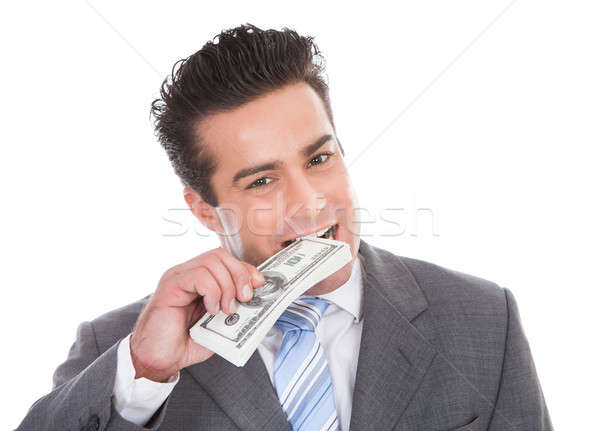 Businessman Biting Banknotes Stock photo © AndreyPopov