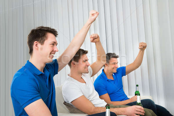 Men Holding Beer Bottles Cheering Stock photo © AndreyPopov