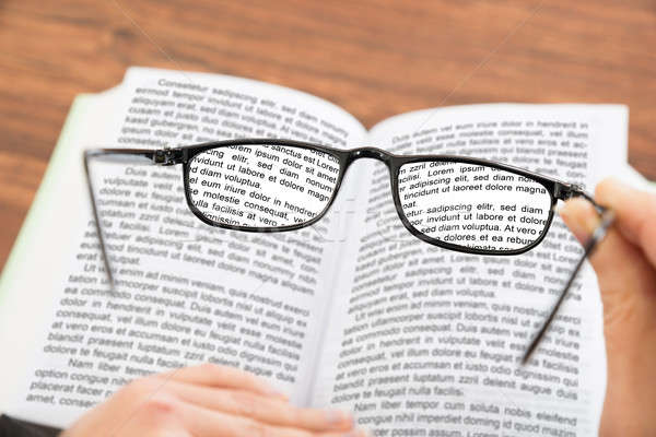 Person Hand Holding Glasses With Book Stock photo © AndreyPopov