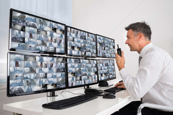 Security System Operator Looking At CCTV Footage Stock photo © AndreyPopov
