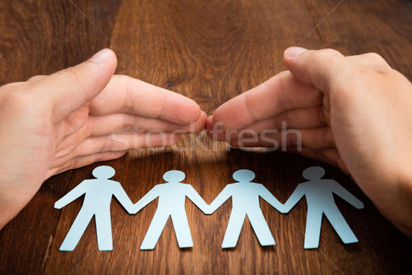 Person Hand Protecting Human Figure Cutout Stock photo © AndreyPopov