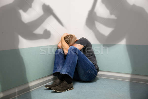 Sombra dos personas hombre abuso sesión esquina Foto stock © AndreyPopov
