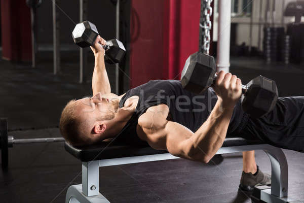 Stock photo: Young Man Working Out In Gym