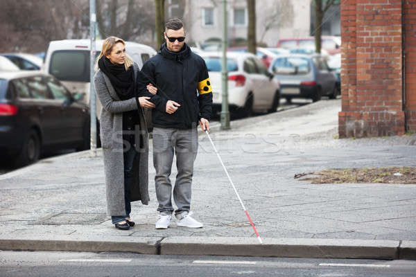 Woman Assisting Blind Man On Street Stock photo © AndreyPopov