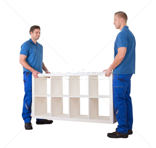 Two Professional Movers Placing The Shelf In New Home Stock photo © AndreyPopov