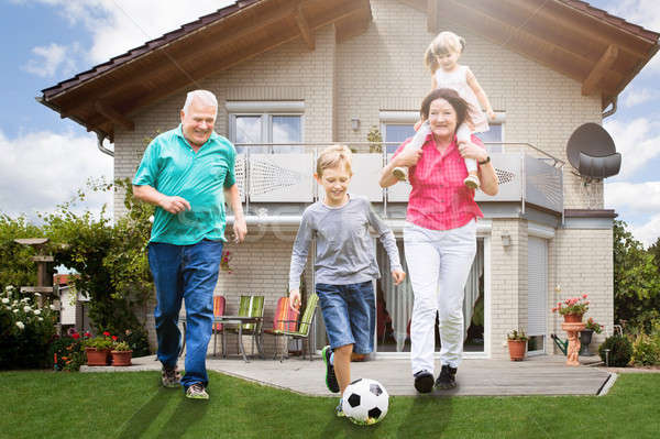 Abuelos jugando fútbol nietos feliz fuera Foto stock © AndreyPopov