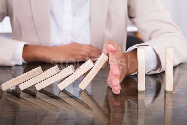 Hand Stopping Wooden Blocks From Falling Stock photo © AndreyPopov