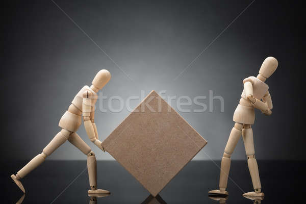 Wooden Dummy Lifting Cardboard Box Suffering From Back Pain Stock photo © AndreyPopov