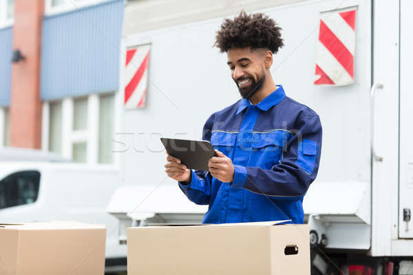 Delivery Man Checking His Order On Digital Tablet Stock photo © AndreyPopov