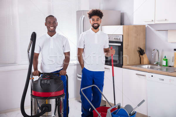 Portrait Of Two Happy Male Janitor In The Kitchen Stock photo © AndreyPopov