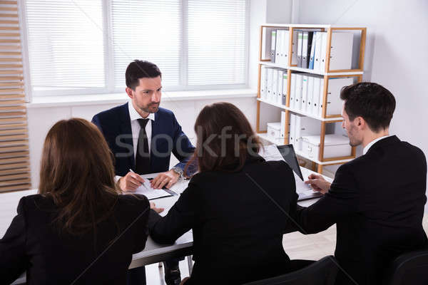 Group Of Businesspeople Discussing Paperwork Stock photo © AndreyPopov