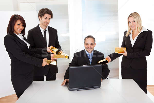 Businessman receiving gold bars Stock photo © AndreyPopov