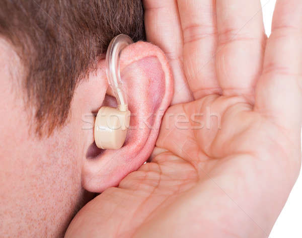 Férfi visel hallókészülék hallgat csendes hang Stock fotó © AndreyPopov
