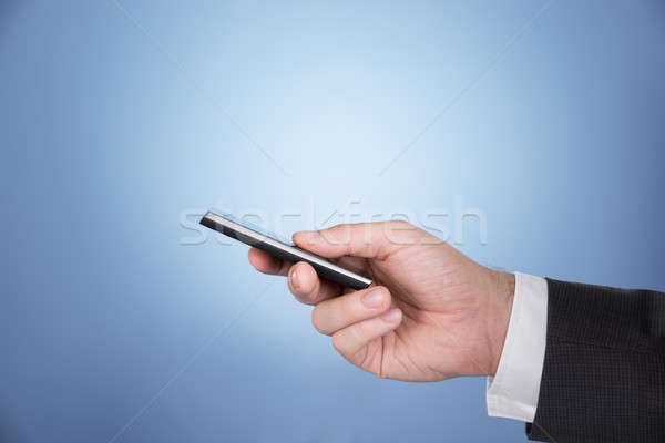 Hand holding mobile phone Stock photo © AndreyPopov