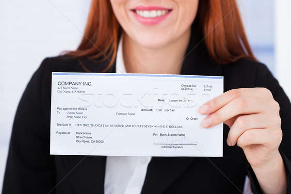 Lächelnd Geschäftsfrau halten Scheck Büro Frau Stock foto © AndreyPopov
