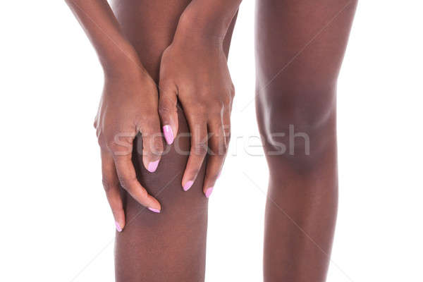 Afro-amerikaanse vrouw lijden knie pijn witte Stockfoto © AndreyPopov