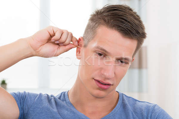 Man Cleaning His Ear Stock photo © AndreyPopov