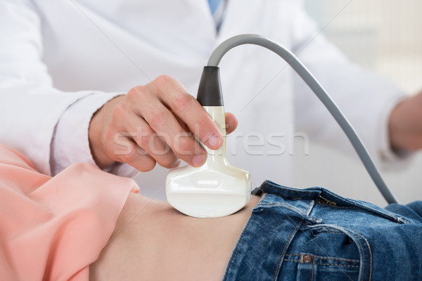 Doctor Moving Ultrasound Probe On Pregnant Woman's Stomach Stock photo © AndreyPopov
