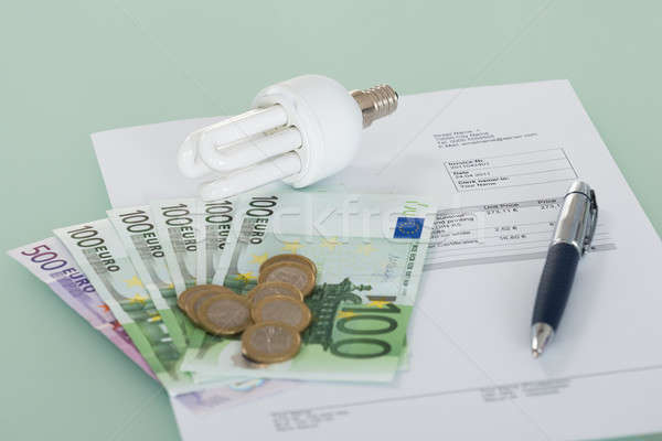 Fluorescent Light Bulb With Invoice And Currency Stock photo © AndreyPopov
