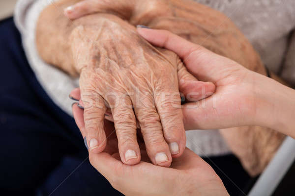 Female Doctor Holding Hand Of Senior Patient Stock photo © AndreyPopov