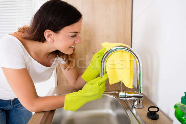 Happy Woman Cleaning The Tap Stock photo © AndreyPopov