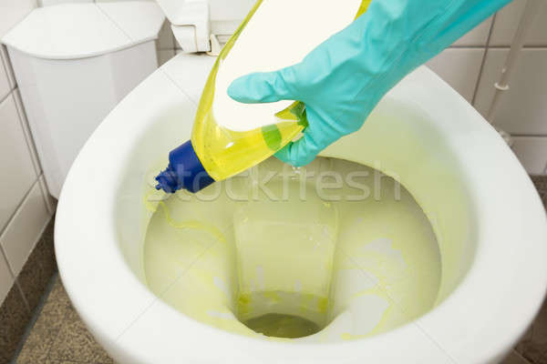 Person Cleaning Toilet Bowl Using Detergent Stock photo © AndreyPopov