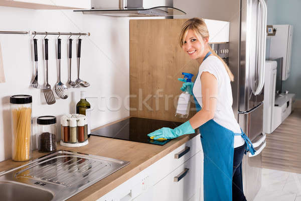 Frau Reinigung Herd Küche jungen lächelnd Stock foto © AndreyPopov