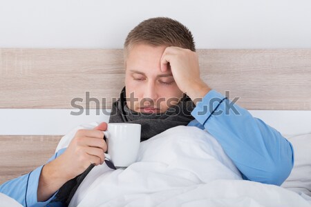 Man Vomiting In Bucket At Home Stock photo © AndreyPopov