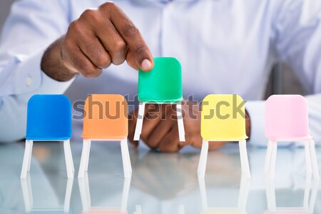 Close-up of businessperson choosing red chair Stock photo © AndreyPopov