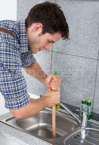Young Man With Plunger Stock photo © AndreyPopov