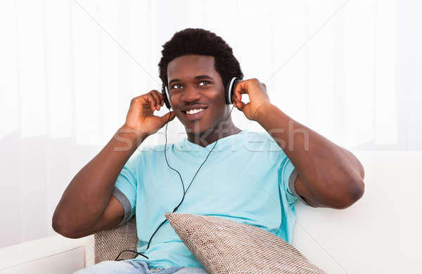 Young Man Listening On Headphone Stock photo © AndreyPopov