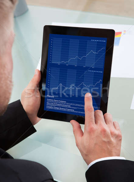 Businessman navigating on his tablet-pc Stock photo © AndreyPopov
