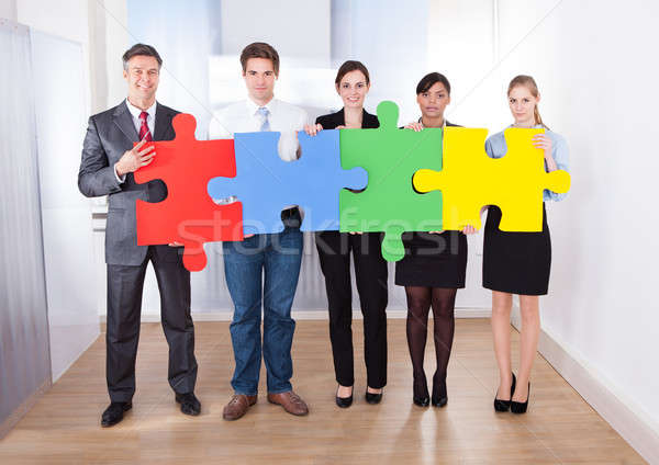 Businesspeople Assembling Jigsaw Puzzle Stock photo © AndreyPopov