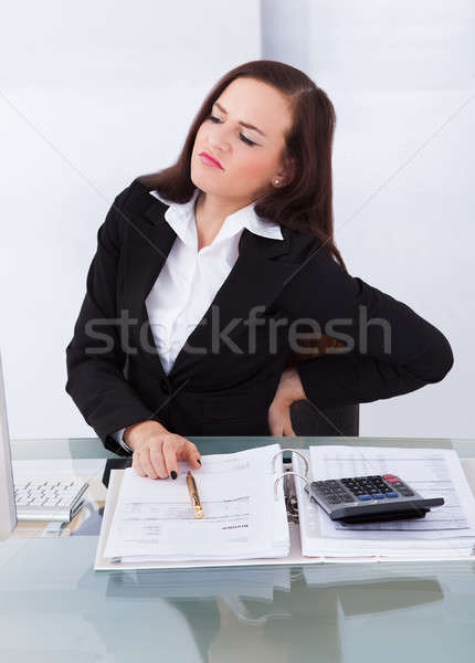 Podatku konsultant cierpienie ból w krzyżu biurko młodych Zdjęcia stock © AndreyPopov