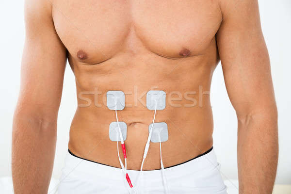 Man With Electrodes On Stomach Stock photo © AndreyPopov