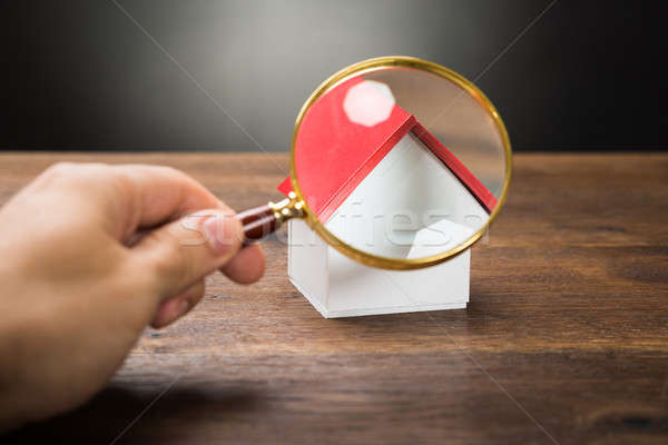 Person Hand With Magnifying Glass And Miniature House Stock photo © AndreyPopov