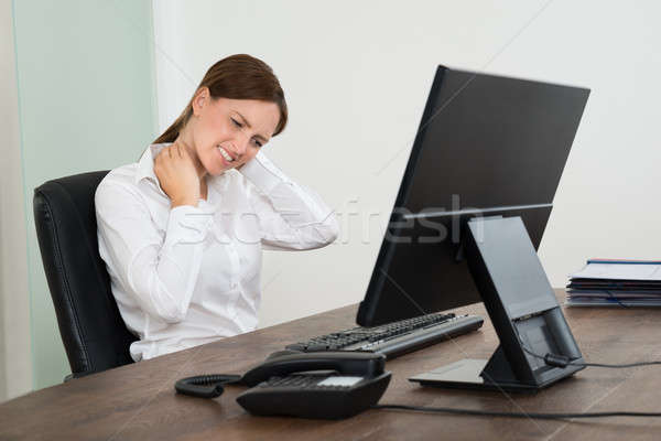 Stock photo: Businesswoman Suffering From Neckache At Desk