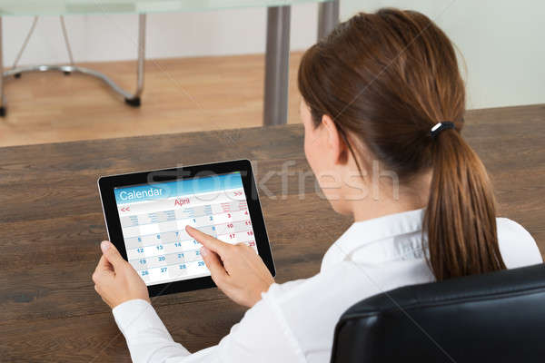Businesswoman Looking At Calendar On Digital Tablet Stock photo © AndreyPopov