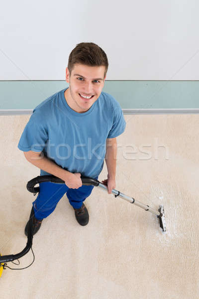 Male Janitor Vacuuming Corridor Stock photo © AndreyPopov
