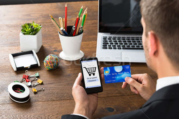 Businessperson With Credit Card And Mobile Phone Stock photo © AndreyPopov