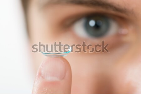 Mann halten Kontaktlinsen Finger junger Mann Stock foto © AndreyPopov