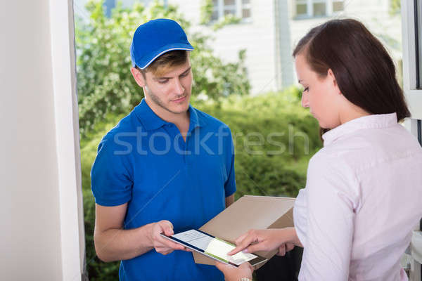 Woman Signing Receipt Of Delivery Package Stock photo © AndreyPopov