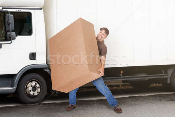 Delivery Man Holding Heavy Box Stock photo © AndreyPopov