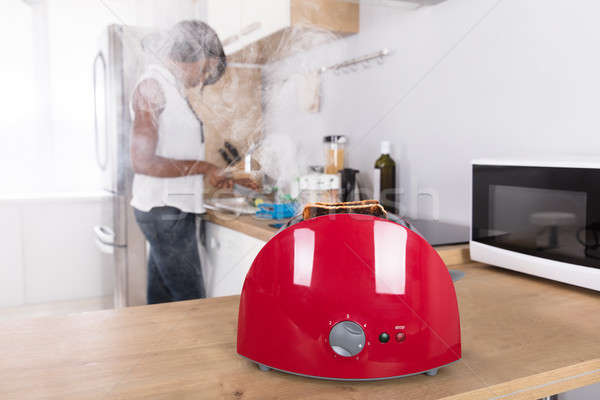 Close-up Of A Red Toaster With Burnt Toast Stock photo © AndreyPopov