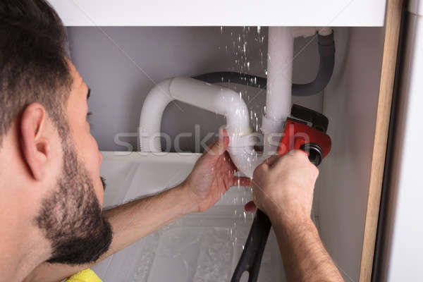 Man Repairing Sink Pipe Leakage Stock photo © AndreyPopov