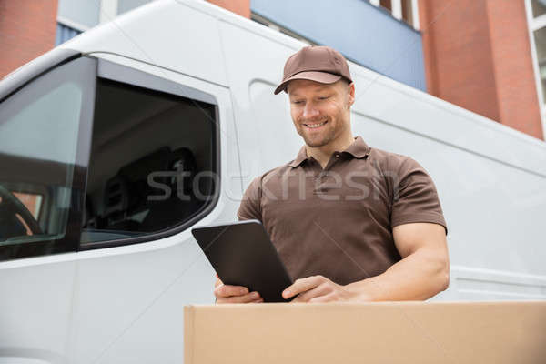Delivery Man Using Digital Tablet Stock photo © AndreyPopov